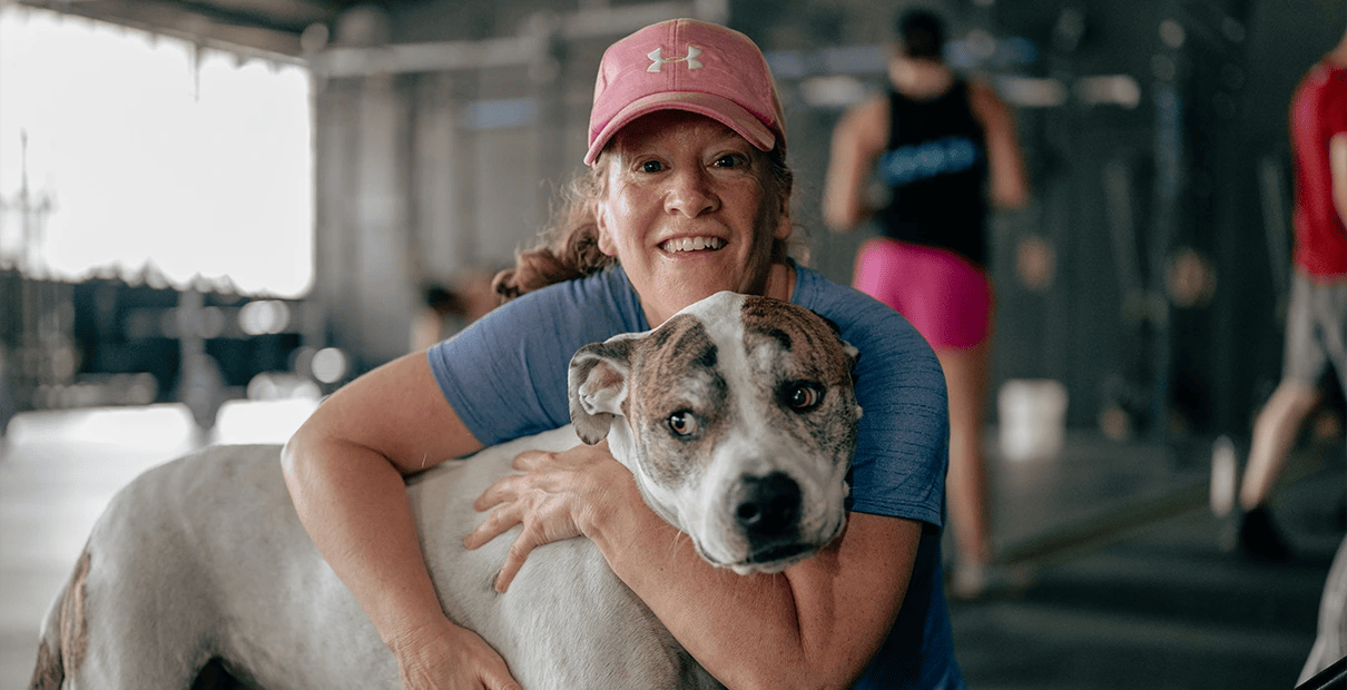 woman exercising with a dog at Marble Strength